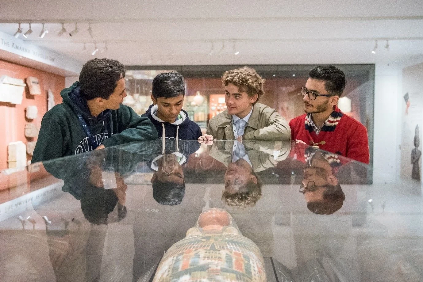 Four students visiting mummy at British Museum