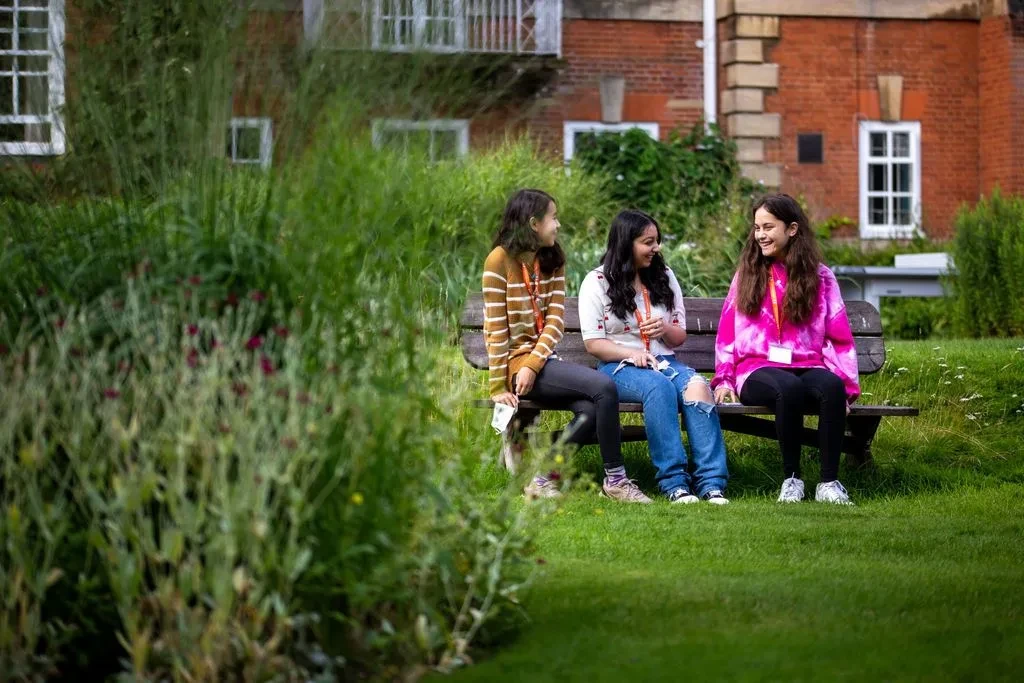Three Students sitting in Lady Margaret Hall garden